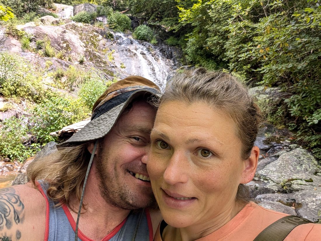 Locomotive and Thumper at a waterfall on trail